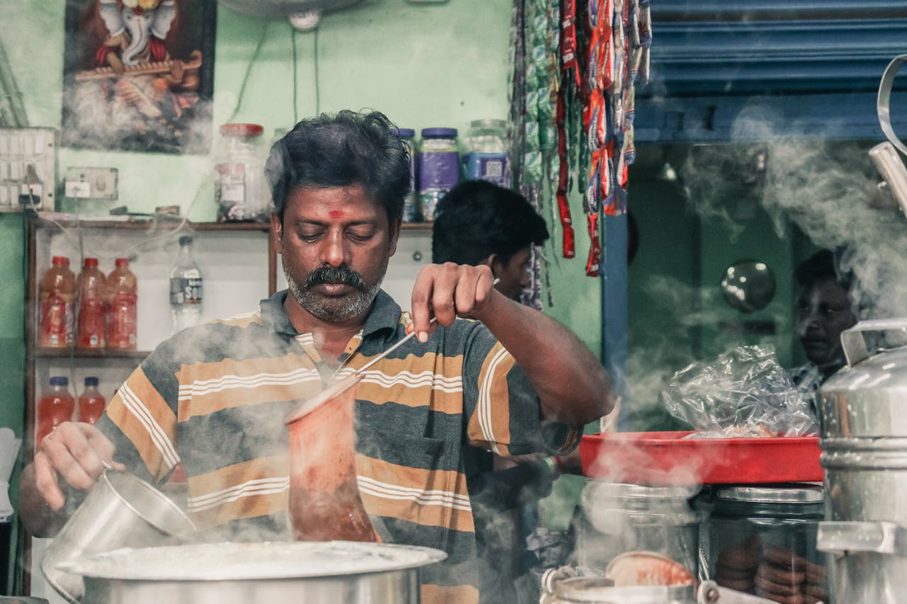 Man Preparing a Hot Drink at a Market